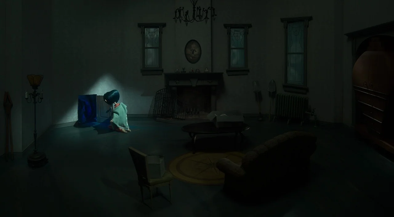 Coraline (2009) movie still: wide — A dim, sparsely furnished room features dark walls, a central fireplace, and heavy vintage furniture. A young…