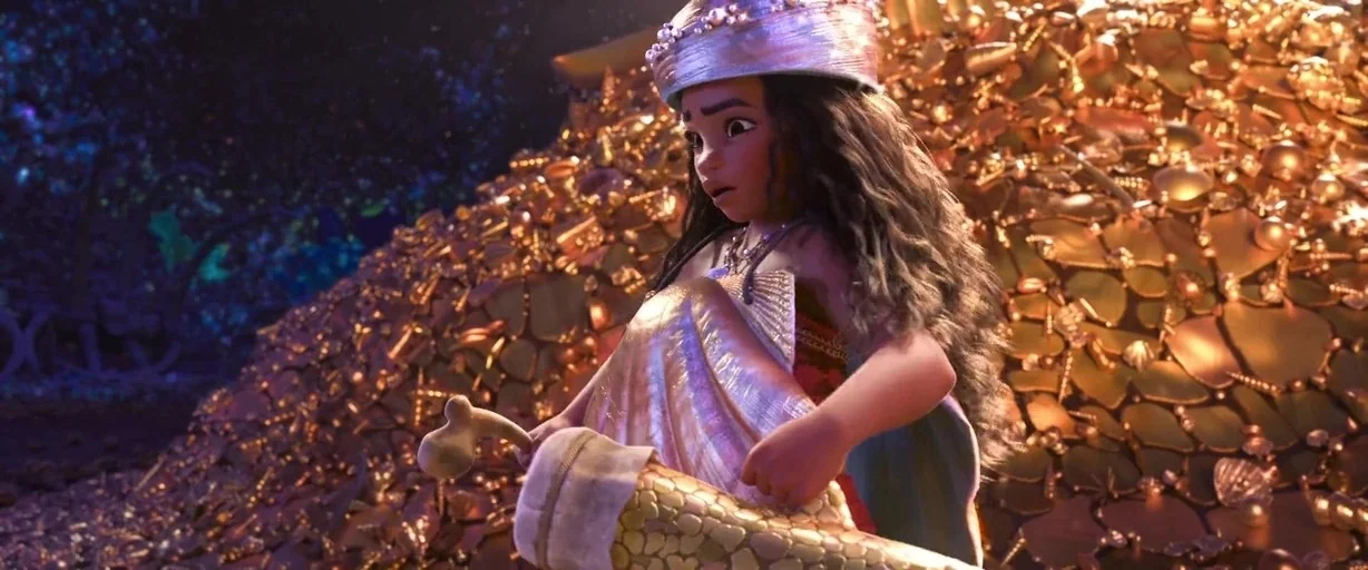 Moana (2016) movie still: medium — A dark subterranean space is piled high with mounds of glimmering gold treasure items. A young woman stands…