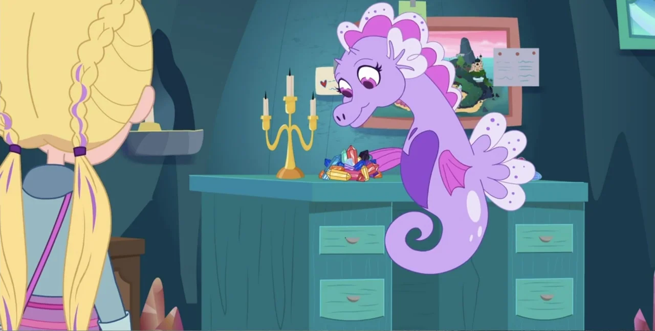 Polly Pocket Sparkle Cove Adventure (2023) movie still: medium — An underwater room contains a blue desk with a collection of colorful crystals. A…
