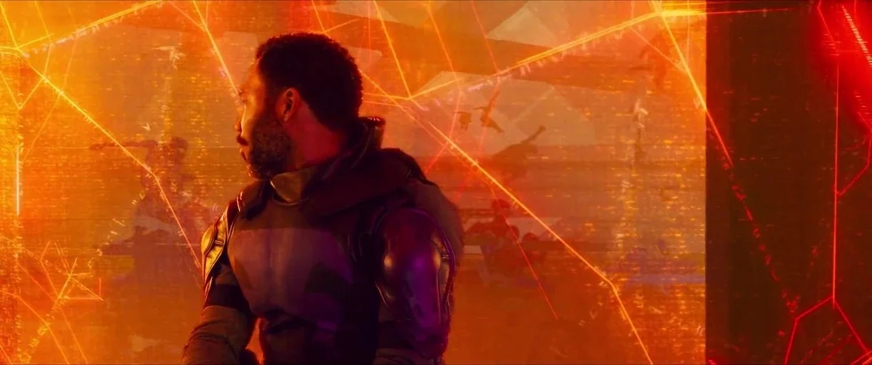 Spider-Man: Across the Spider-Verse (2023) movie still: medium — A dark, cramped interior space glows with bright orange geometric digital…