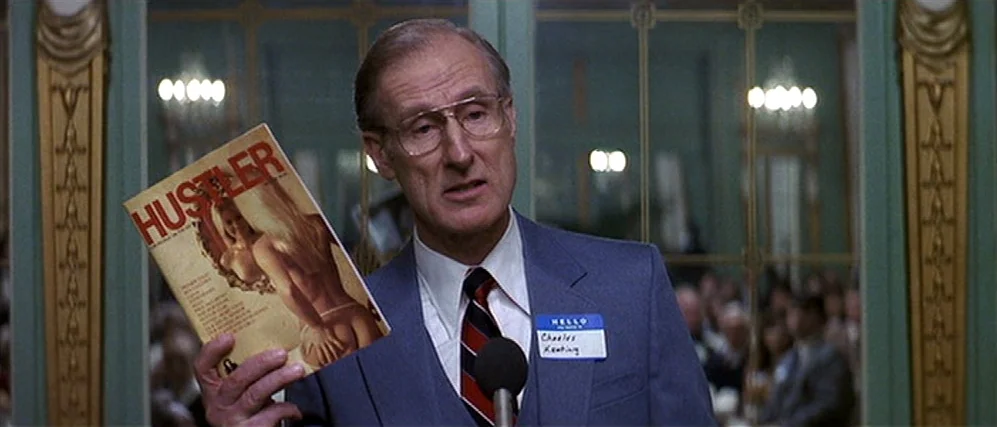 The People vs. Larry Flint (1996) movie still: medium — A formal event held in a banquet hall featuring paneled walls and mirror accents. A man in a…