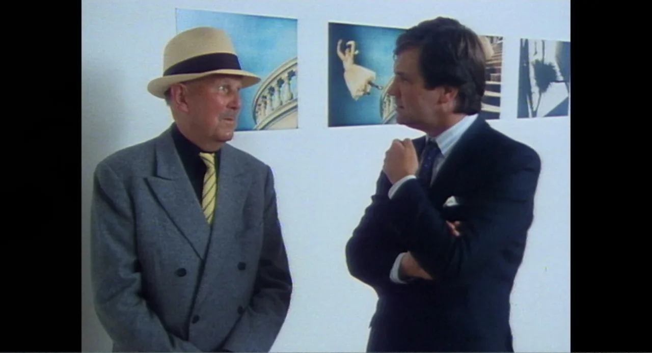 Made in England: The Films of Powell and Pressburger (2024) movie still: medium — A stark white interior space features framed photographic prints…