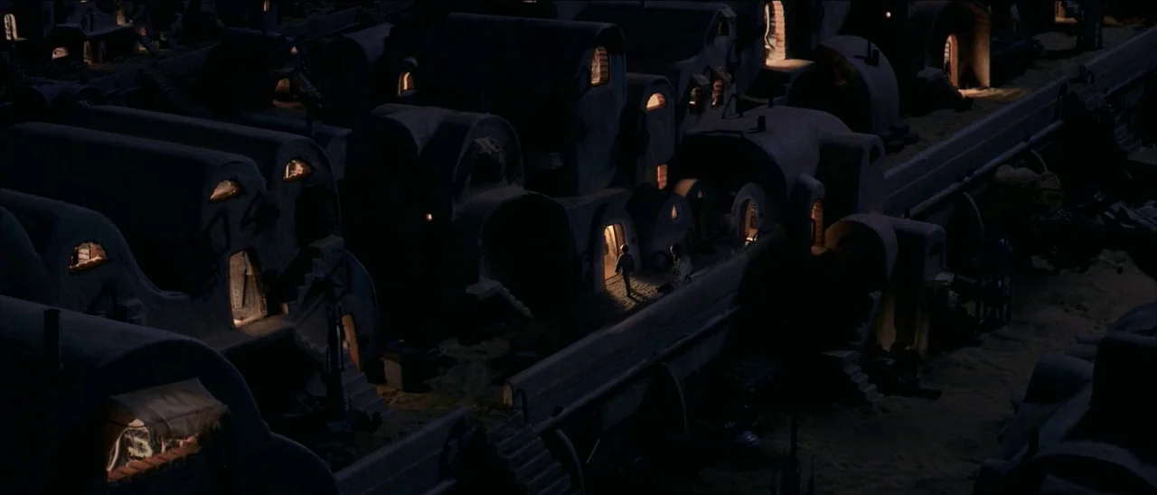 Star Wars: Episode I – The Phantom Menace (1999) movie still: wide — A dense desert village constructed of rounded mud-brick structures sits under a…