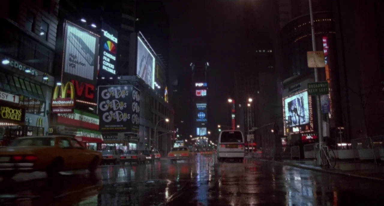 Hellraiser III: Hell on Earth movie still: wide — A rain-slicked Times Square at night is lined with towering illuminated commercial advertising…