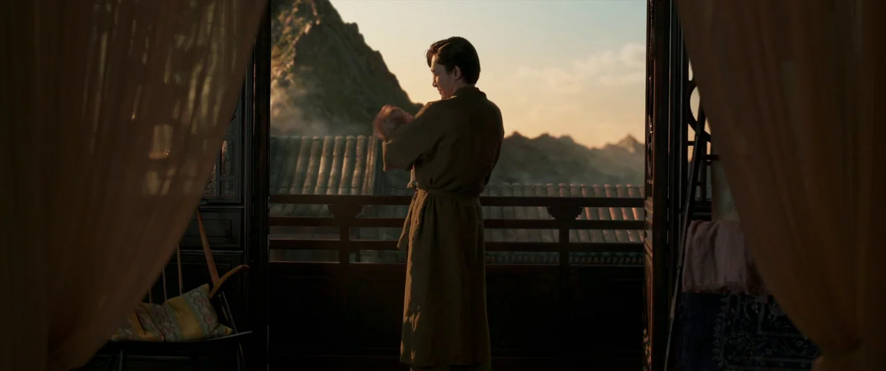 Shang-Chi and the Legend of the Ten Rings (2021) movie still: fullbody — An open balcony overlooks a terraced mountain landscape during the golden…