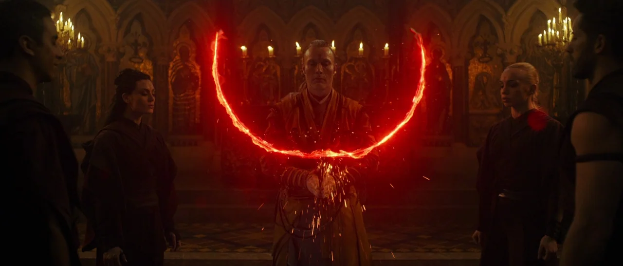 Doctor Strange (2016) movie still: wide — A stone cathedral interior with religious iconography illuminated by flickering candles in the background.…