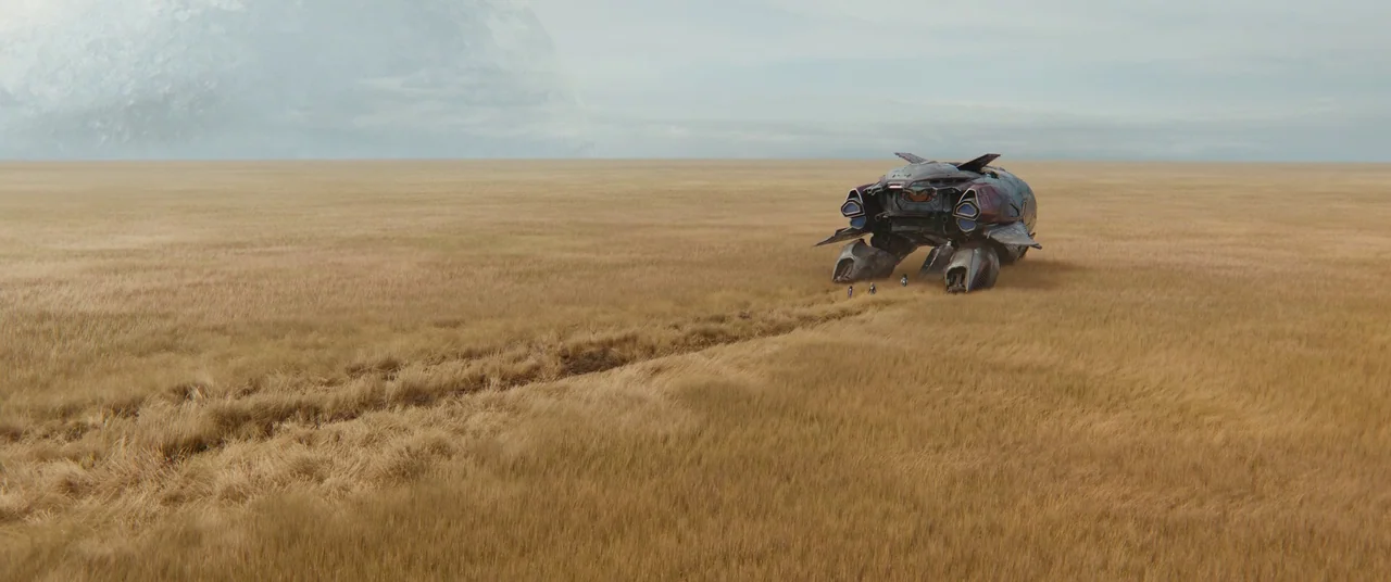 The Marvels (2023) movie still: wide — A vast, flat plain covered in golden dry grass stretches toward a cloudy horizon. A heavy, weathered…