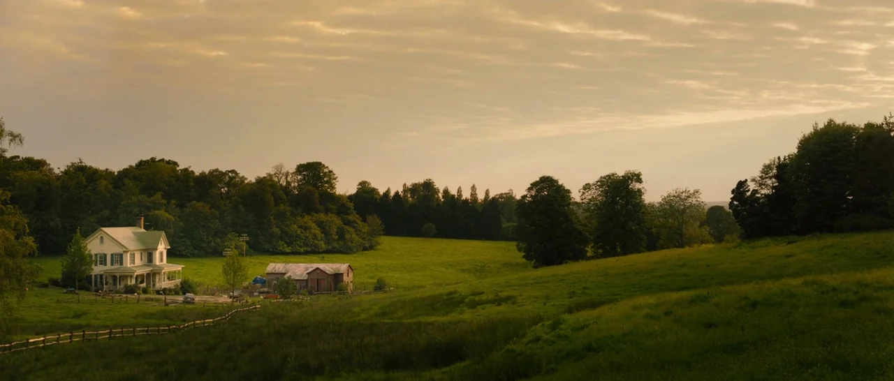 Avengers: Age of Ultron (2015) movie still: establishing — A rural farm with a white house and barn sits nestled in a valley. Rolling green hills…