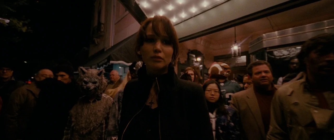 Silver Linings Playbook (2012) movie still: medium — A dense crowd stands outside an old theater marquee at night in the city. The main subject…