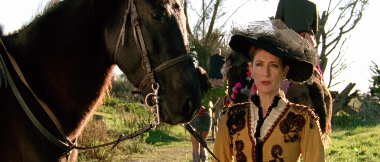 Arabian Nights: Volume 1 – The Restless One (2015) movie still: medium — An open grassy area contains a woman in formal period attire and a horse.…
