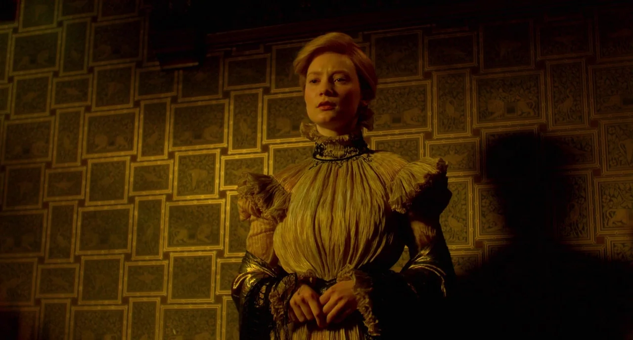 Crimson Peak (2015) movie still: medium — An interior space features patterned wallpaper with rectangular frames displaying animal motifs. A woman…