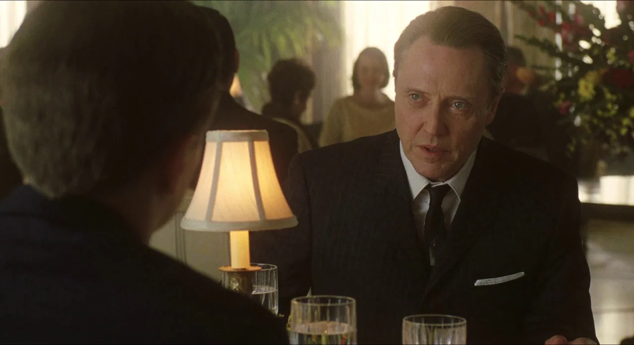 Catch Me If You Can (2002) movie still: medium — An upscale restaurant features floral arrangements and soft daylight filtering through large…