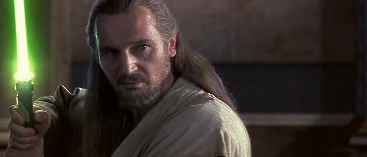 Star Wars: Episode I – The Phantom Menace (1999) movie still: medium — A dimly lit stone corridor serves as the backdrop for a tense confrontation.…