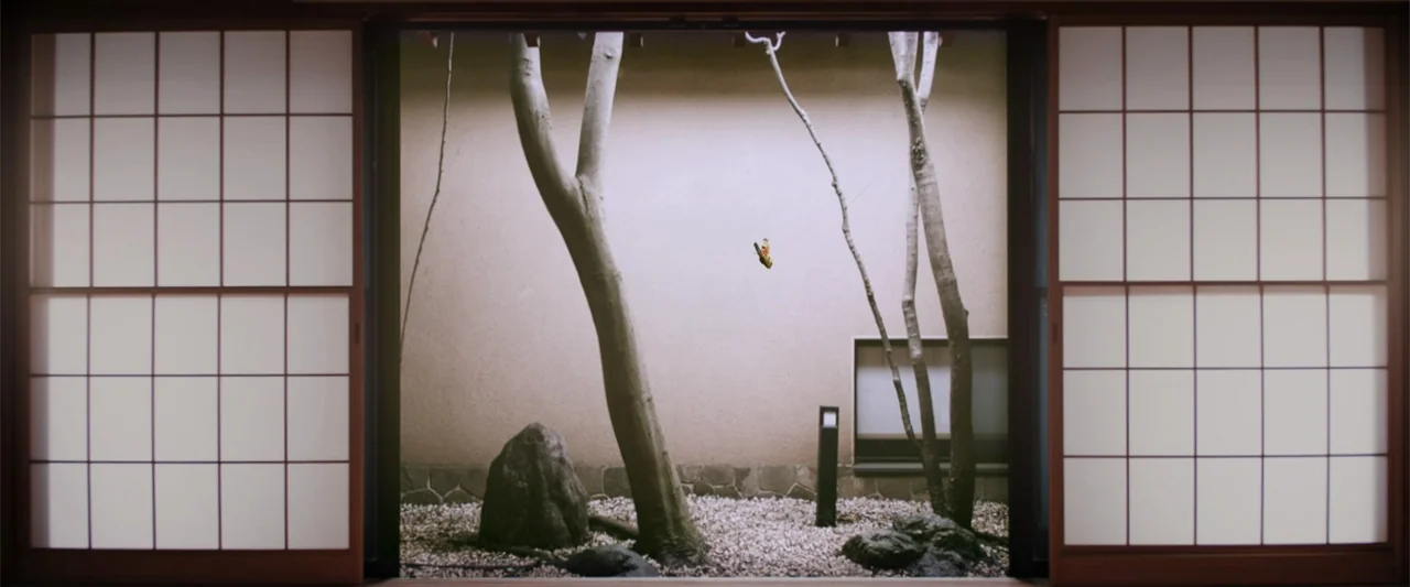 To Hear the Birds Singing (1995) movie still: establishing — A traditional Japanese courtyard is framed by open wooden shoji screen sliding doors. A…