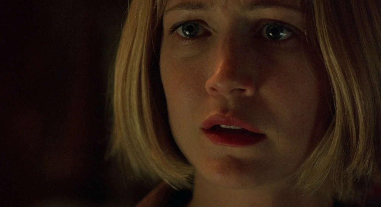 Candyman: Farewell to the Flesh (1995) movie still: closeup — A dark indoor setting with limited illumination on the subject. A woman with blonde…