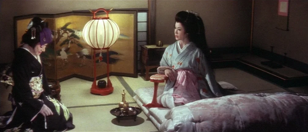 An Actor’s Revenge (1963) movie still: medium — A traditional Japanese room features tatami mats and a folding screen with crane art. Two women in…