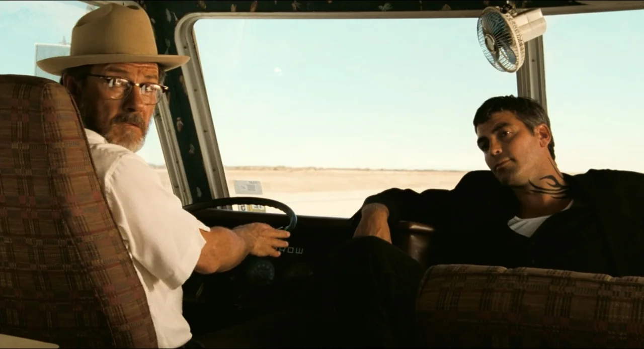 From Dusk Till Dawn (1996) movie still: medium — An interior of a motorhome features patterned upholstery and a small electric cooling fan. An older…