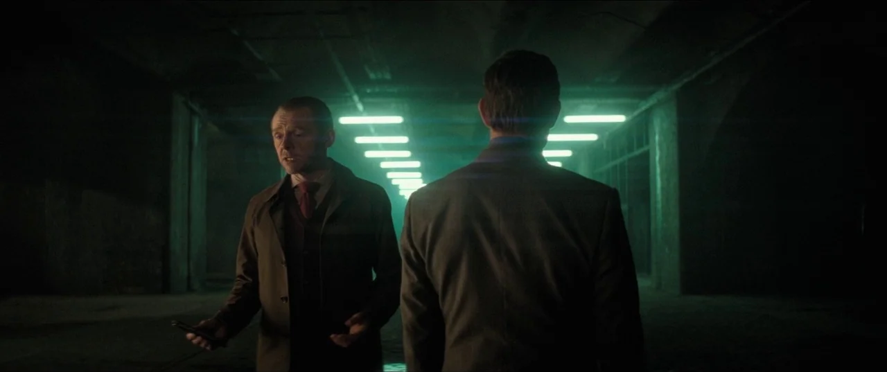 Mission: Impossible – Fallout (2018) movie still: medium — An industrial concrete tunnel features rows of suspended green fluorescent lights. A man…