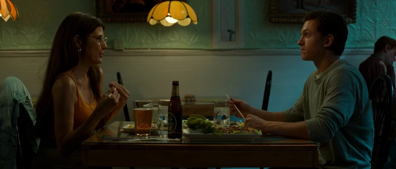 Spider Man: Homecoming (2017) movie still: medium — A restaurant interior features pale green walls with decorative relief patterns and framed art.…