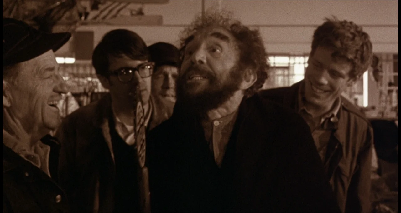 The Dunwich Horror (1970) movie still: medium — A group of four men stand in a cluttered commercial shop interior. The men are talking to one…