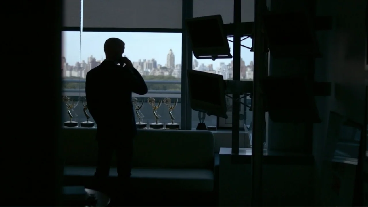 Nothing Left Unsaid: Gloria Vanderbilt & Anderson Cooper (2016) movie still: medium — A high-rise office contains a silhouette of a man standing…