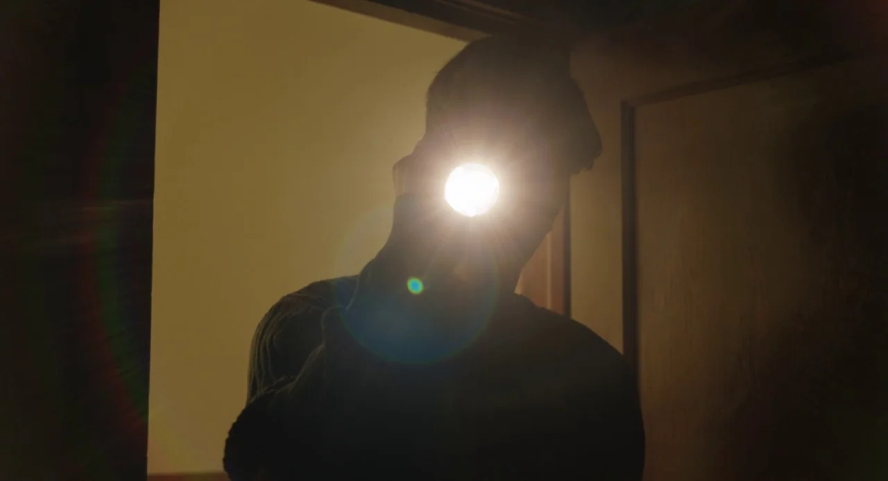 The Miseducation of Cameron Post (2018) movie still: medium — A dark, dimly lit indoor doorway frames a silhouette of a person. The subject holds a…