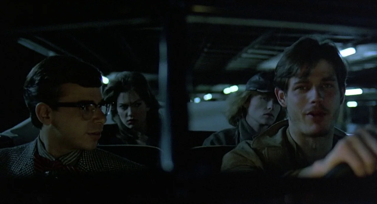 Streets of Fire (1984) movie still: medium — The interior of a car at night contains four occupants sitting in close proximity. A man drives while a…