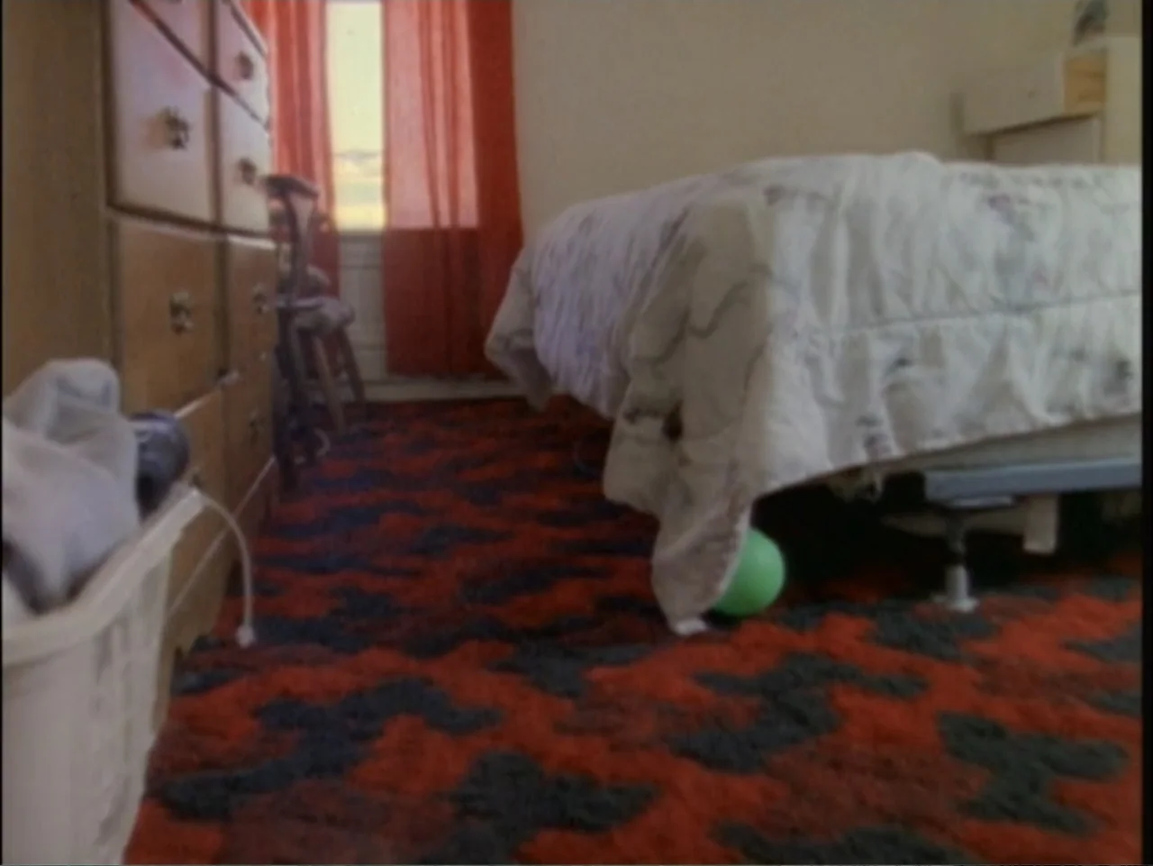 5 American Handguns - 5 American Kids (1995) movie still: medium — A residential bedroom features a bed with a white quilted comforter and a…