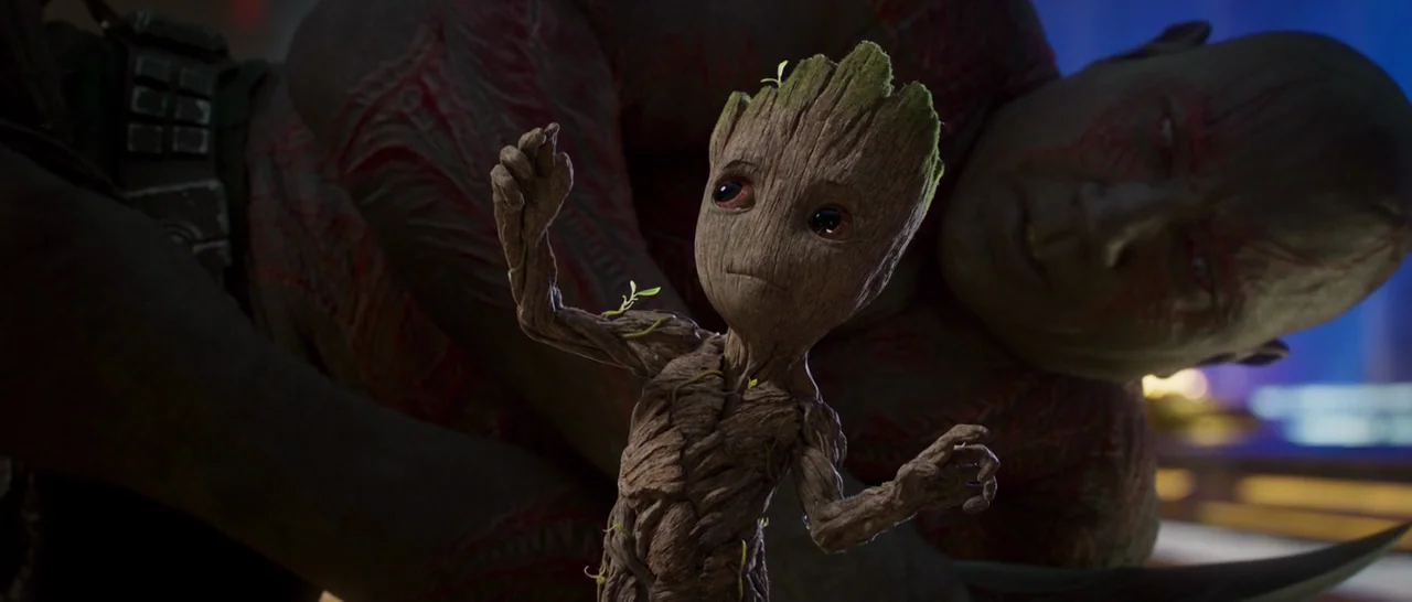 Guardians of the Galaxy Vol. 2 (2017) movie still: medium — A dimly lit interior space features a small wooden creature in the foreground. A large…