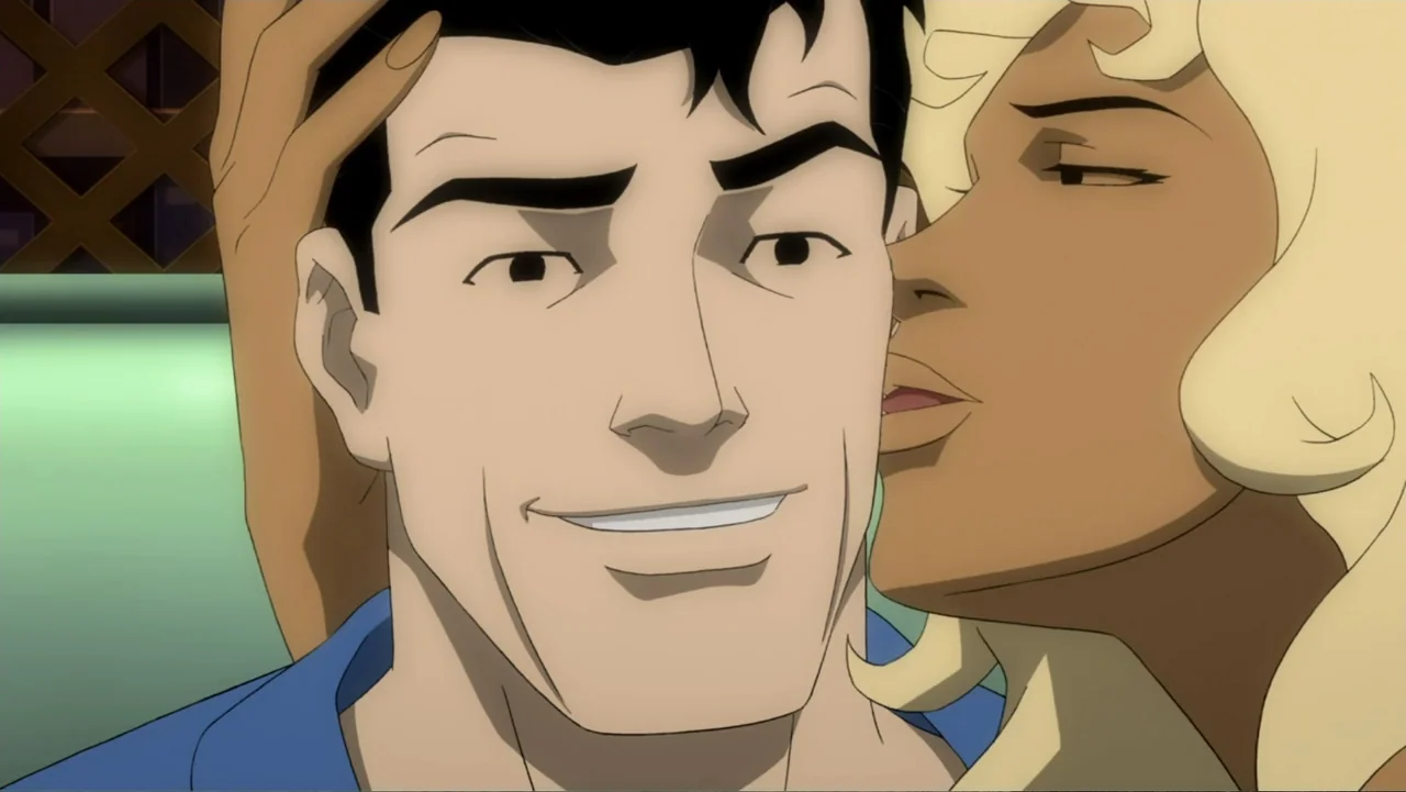 Batman: Year One (2011) movie still: closeup — A man and woman are positioned closely together within an indoor booth setting. The woman leans in to…
