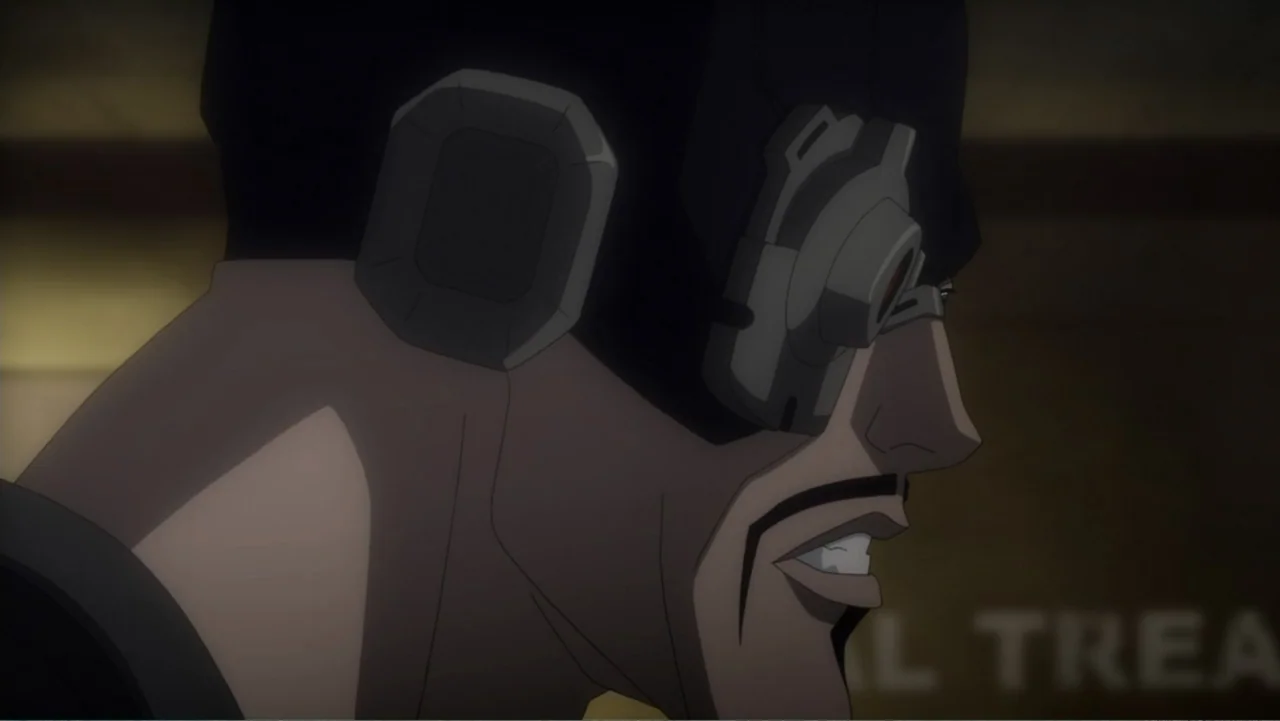 Batman: Assault on Arkham (2014) movie still: closeup — A dimly lit interior space with muted colors. A man in profile wears a technical eyepiece.