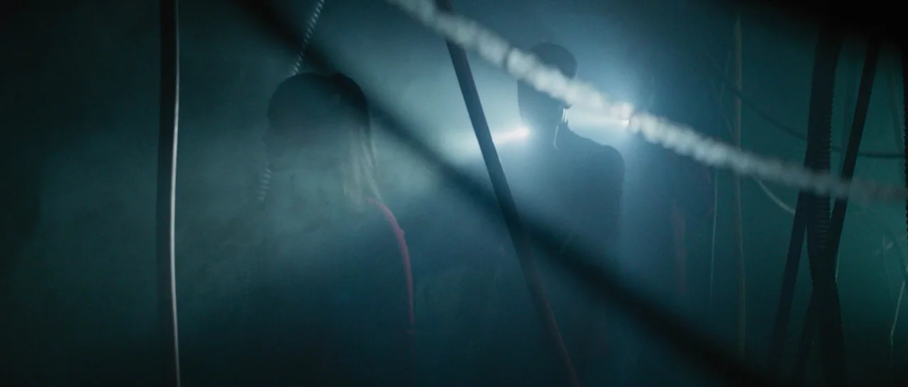 Star Trek Beyond (2016) movie still: medium — A dark, foggy basement filled with numerous hanging cables and wires. Two figures are backlit by…