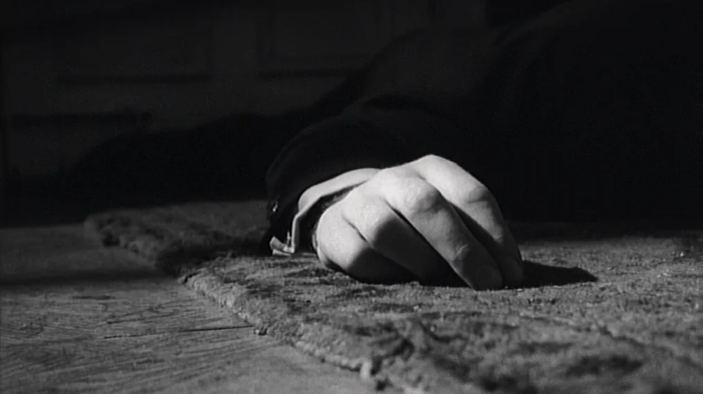 Repulsion (1965) movie still: closeup — A close-up shot focuses on a hand resting upon a thick, woven carpet. The hand is part of an unseen person…