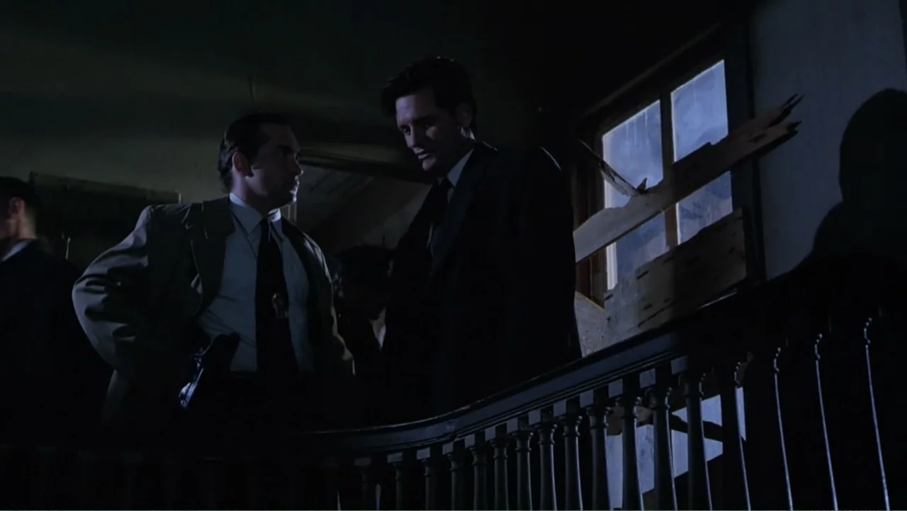 Mistrial (1996) movie still: medium — A dark stairwell landing features a wooden railing and a window covered by boards. Two men in formal suits…