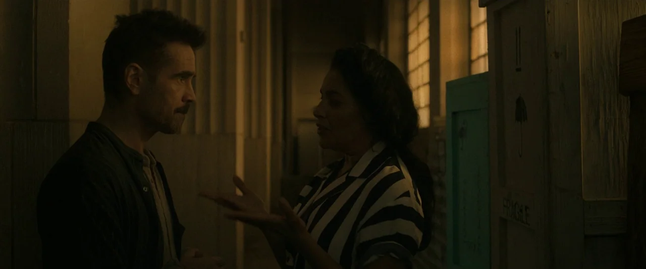 After Yang (2021) movie still: medium — A dimly lit industrial room features stacked wooden crates and large windows with metal frames. A man and a…