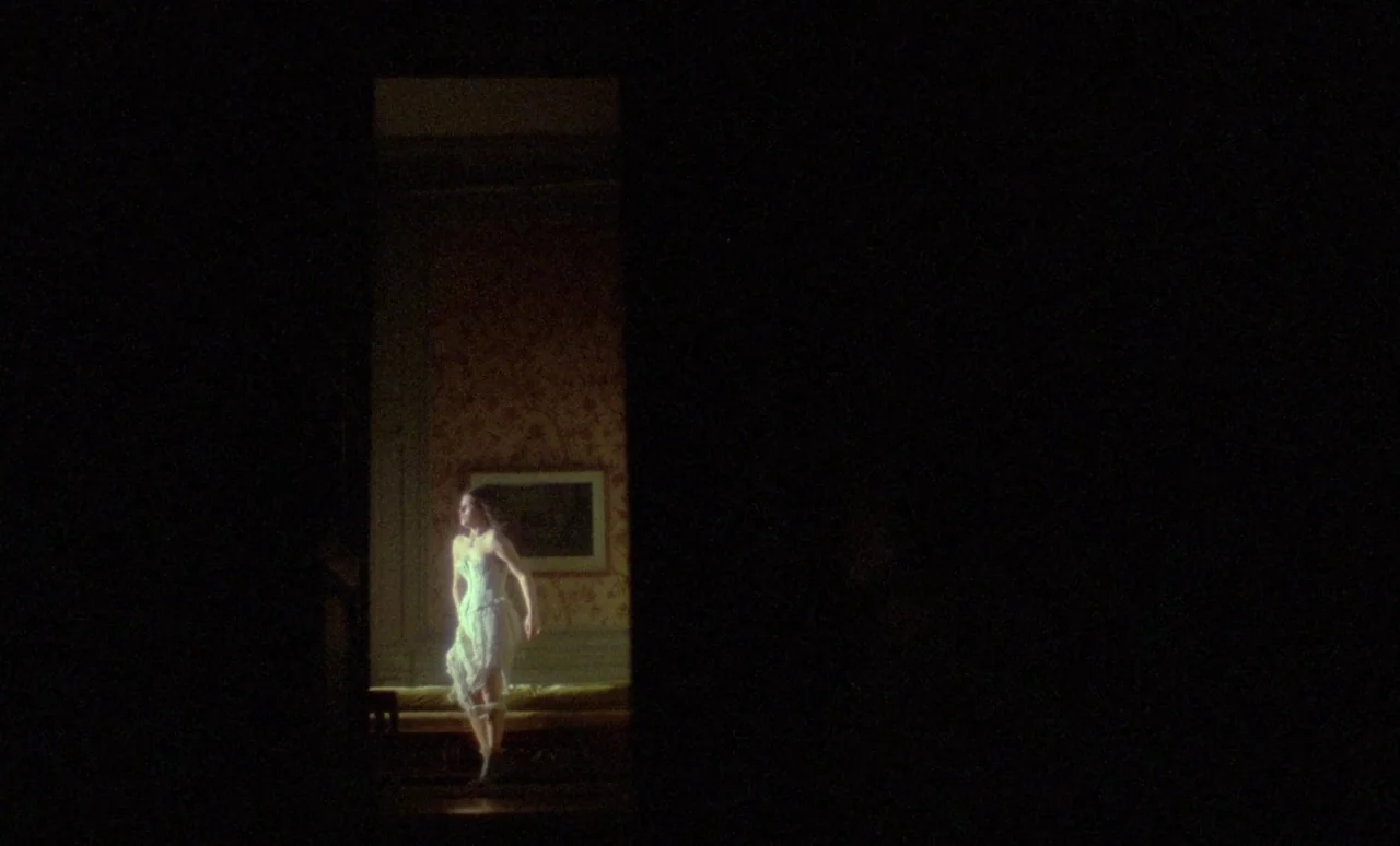 The Strange Case of Dr. Jekyll and Miss Osbourne (1981) movie still: wide — A woman in white undergarments stands within a dark, narrow doorway. The…