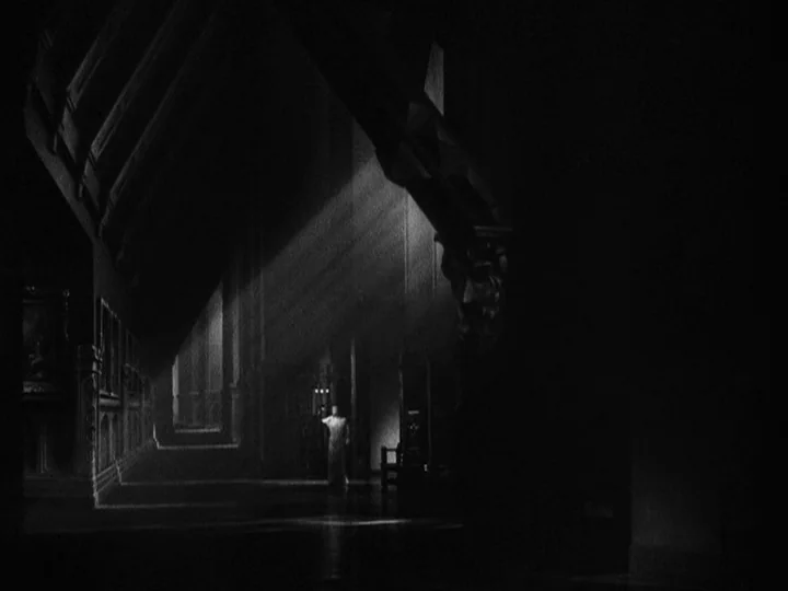 Queen Christina (1933) movie still: wide — A large stone interior with high ceilings and heavy architectural features remains in deep darkness. A…