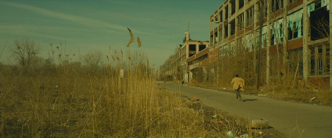 A Most Violent Year (2014) movie still: wide — An abandoned industrial area features large, dilapidated brick factories alongside a cracked paved…