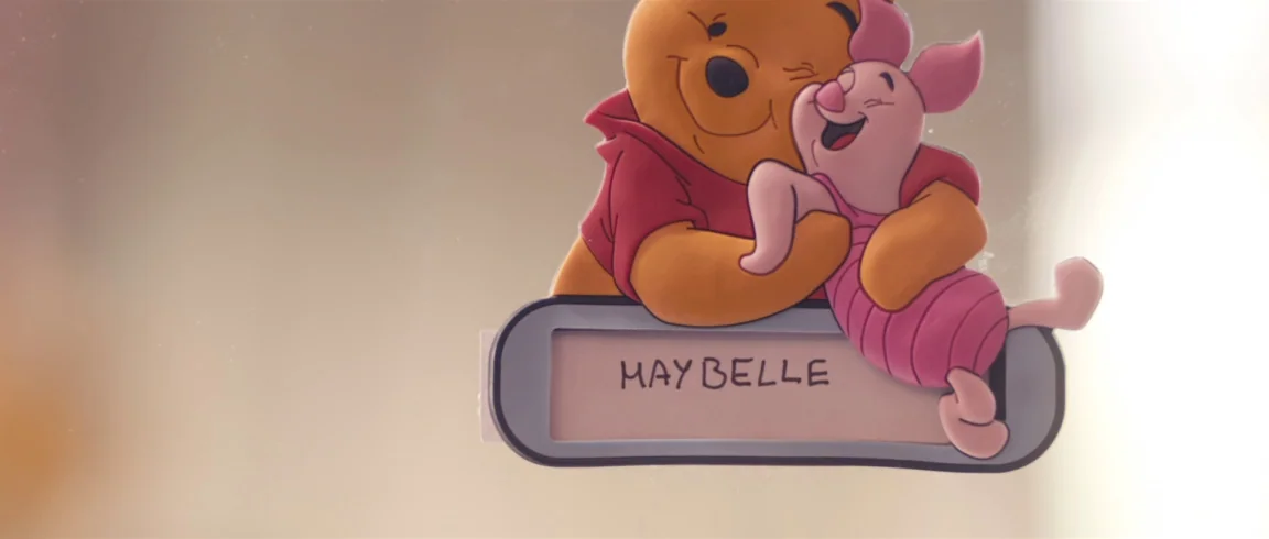 Broken Circle Breakdown (2012) movie still: closeup — A plastic nameplate with the name Maybelle is mounted on a smooth surface. Winnie the Pooh and…