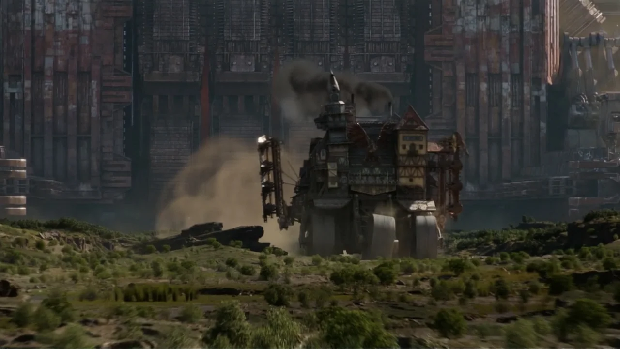 Mortal Engines (2018) movie still: wide — A massive mobile structure made of timber and metal moves across a dusty field. In the background looms an…