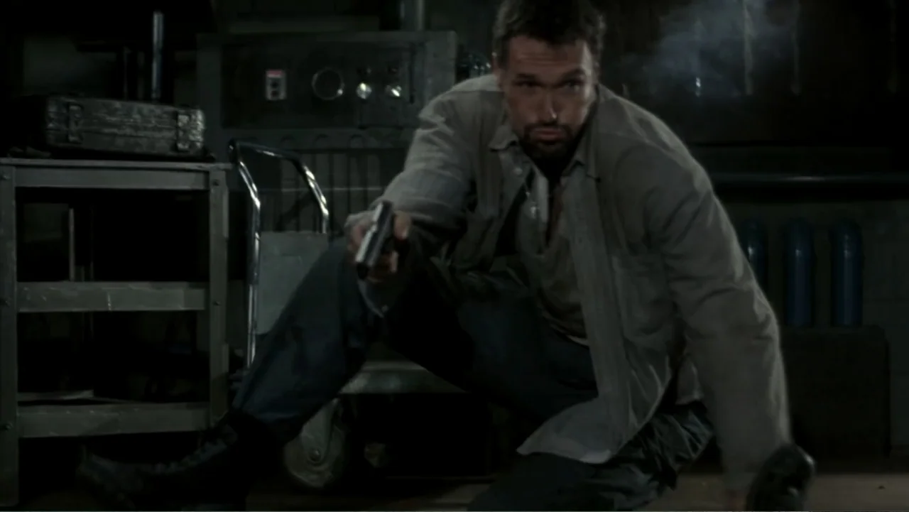 Behind Enemy Lines (2001) movie still: medium — An industrial basement space with dark machinery and concrete floors creates a dim environment. A…