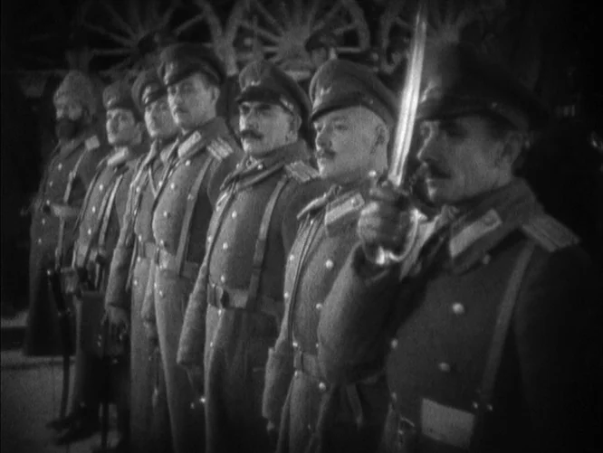 The Last Command (1928) movie still: medium — A line of officers in 1910s military uniforms stands at attention on a parade ground. The foreground…