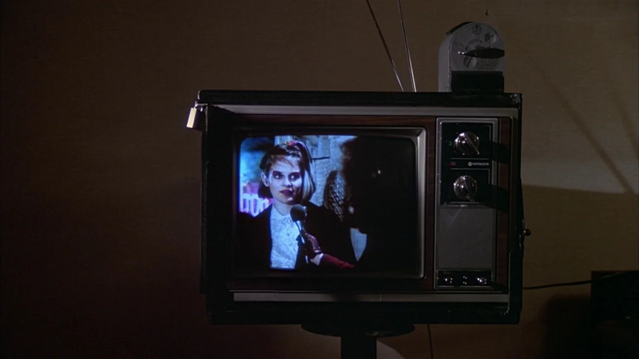 Ladies and Gentlemen, the Fabulous Stains (1985) movie still: closeup — A vintage television set displays a recorded interview of a young woman…