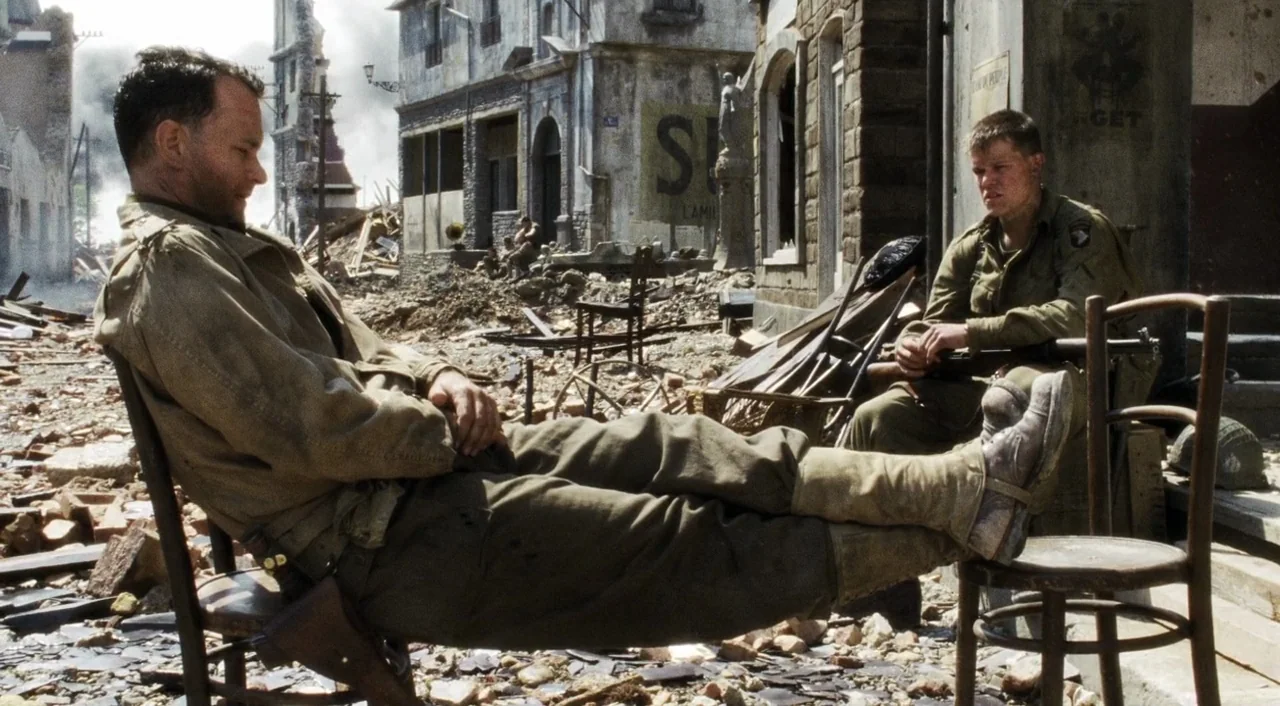 Saving Private Ryan (1998) movie still: wide — A war-torn town square is covered in broken brick, stone, and architectural debris. Two soldiers in…