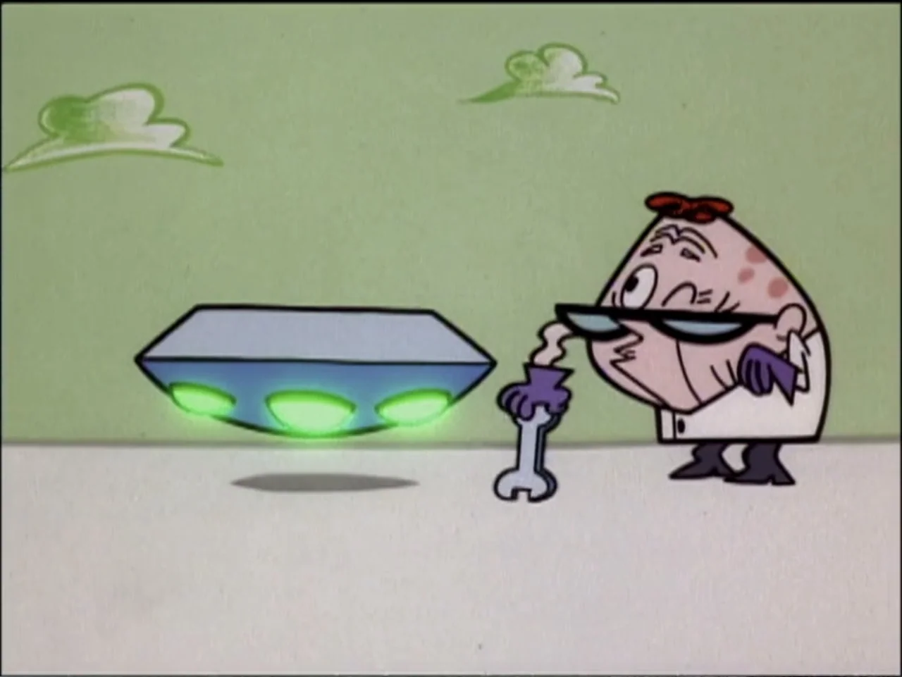 Dexter's Laboratory: Ego Trip (1999) movie still: medium — A stylized cartoon laboratory with a pale green wall and white floor. An elderly-looking…