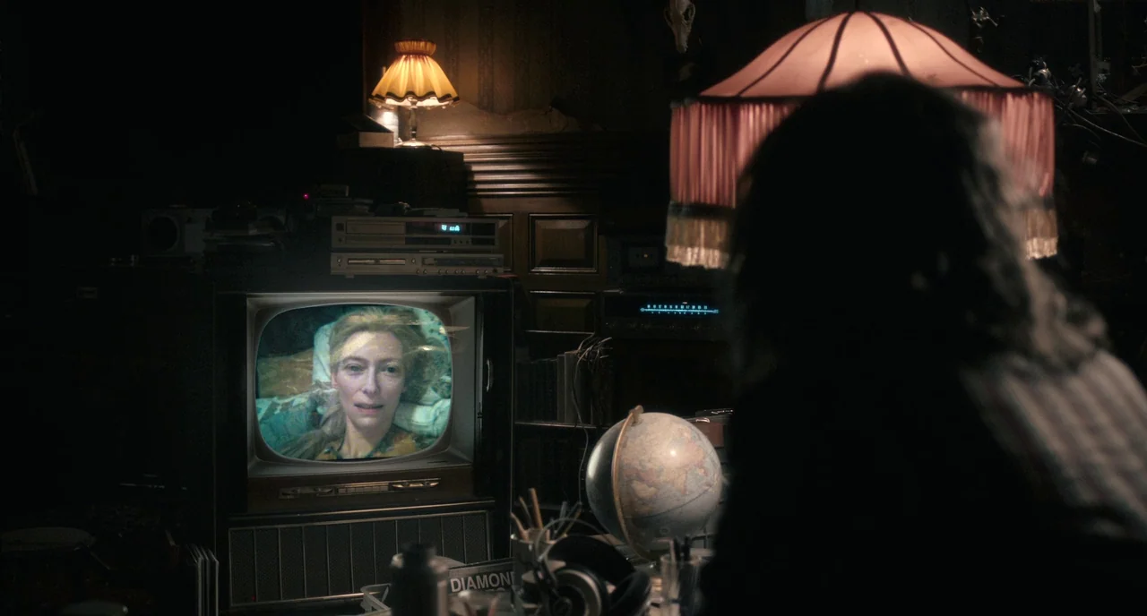Only Lovers Left Alive (2013) movie still: medium — A cluttered room is filled with electronics, a globe, and an old television set. A person sits…