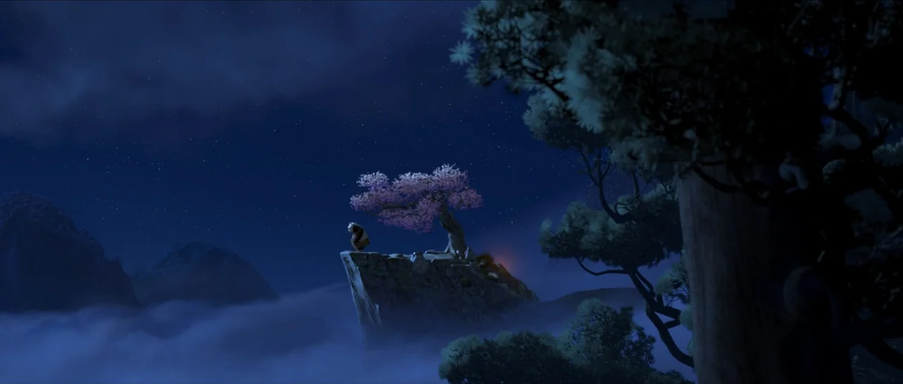 Kung Fu Panda (2008) movie still: wide — A high rocky cliff formation sits above a thick layer of night fog. A large panda character stands near a…