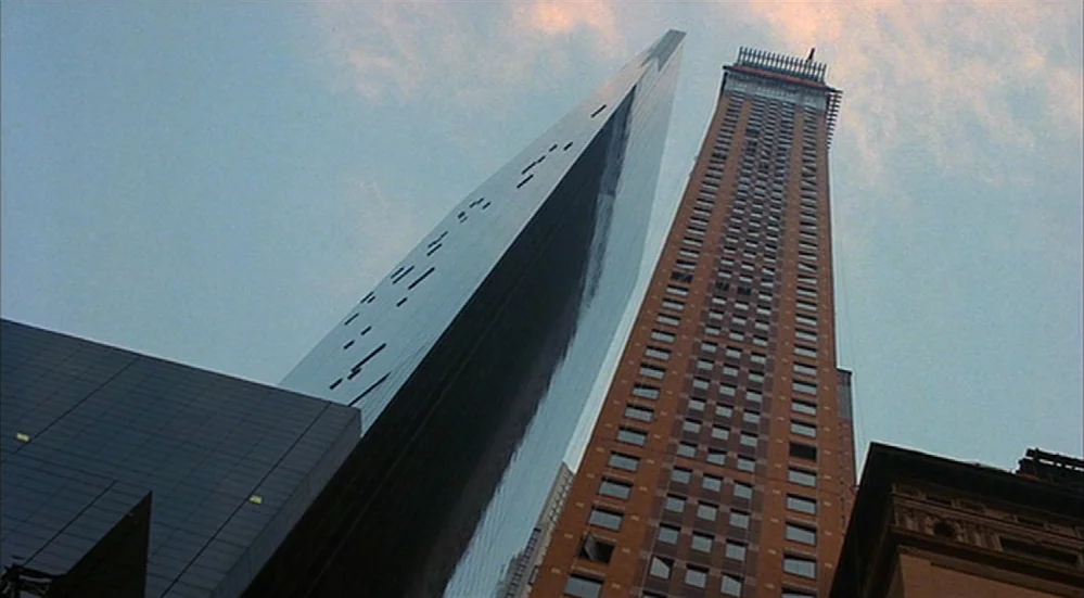 The Fisher King (1991) movie still: establishing — Two skyscrapers rise vertically into a clear sky from a city street perspective. A reflective…