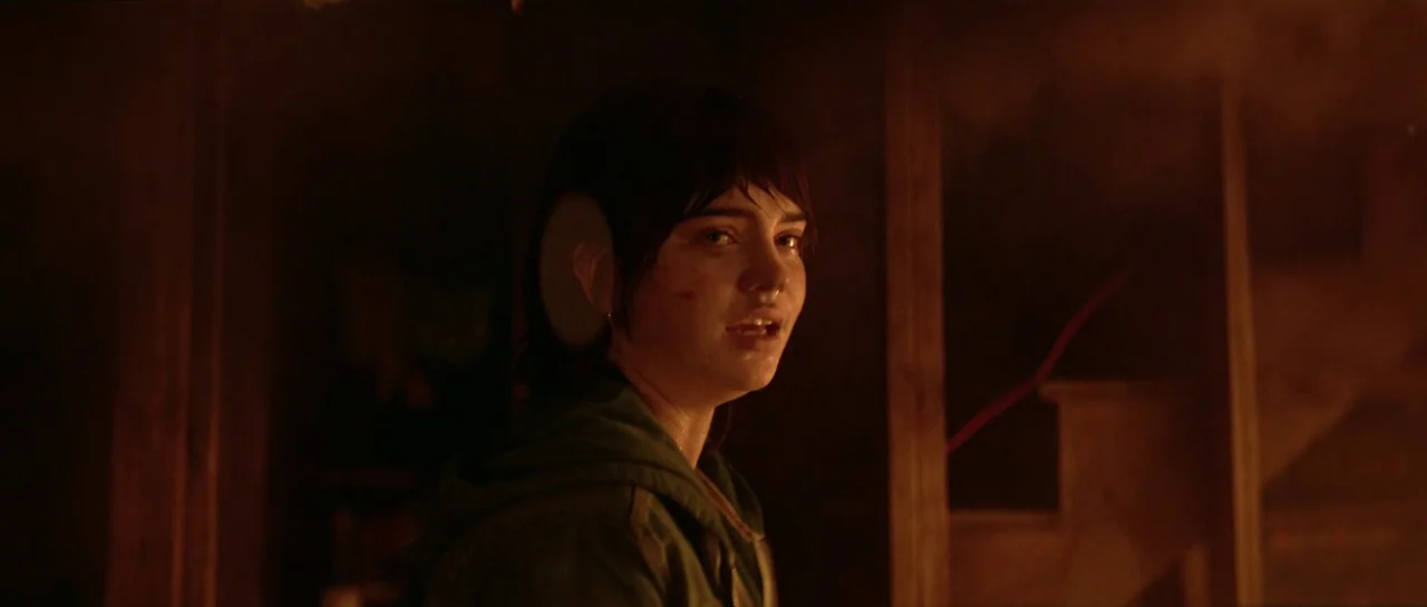 The Boogeyman (2023) movie still: medium — A dark, smoke-filled room is illuminated by a warm, orange firelight source. A young woman with messy…