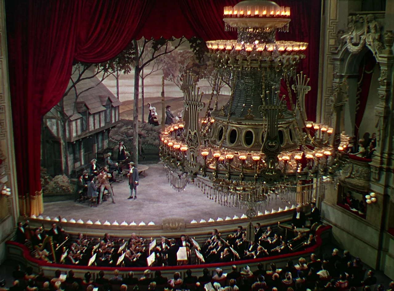 Phantom of the Opera (1943) movie still: wide — A grand, multi-tiered opera house features an ornate golden chandelier suspended over the audience.…